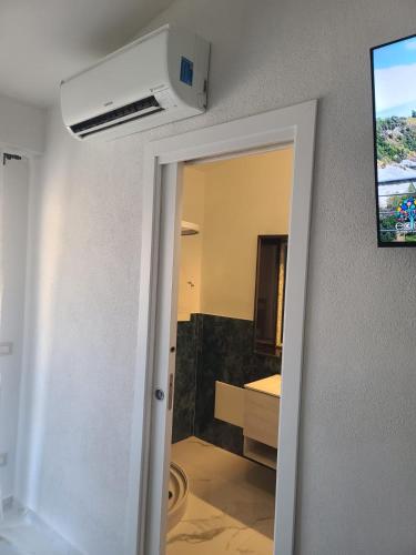 a room with a bathroom with a sink and a room with at Casa Coronas-Domo de zizzi in Orosei