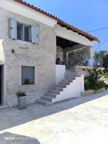 a stone house with stairs on the side of it at Studio Marianna in Oziás