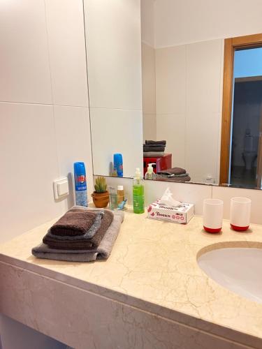 a bathroom counter with a sink and a mirror at Vista Dourada in Porto Santo