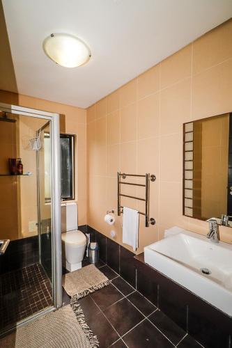 a bathroom with a tub and a toilet and a sink at Heathercreek Accommodation in George