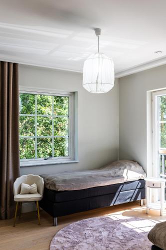 a bedroom with a large bed and a window at Villa Svinninge in Åkersberga