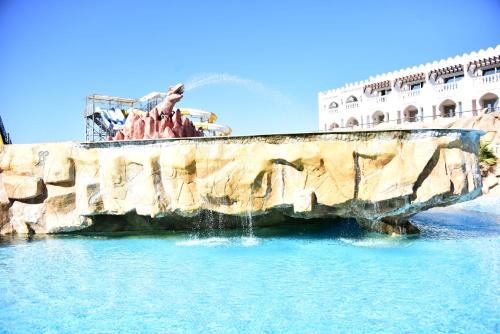 a fountain in the water in front of a building at Hollywood Aqua Park Sharm El-Sheikh in Sharm El Sheikh