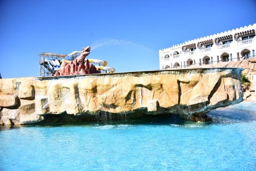 a fountain in the water in front of a building at Hollywood Aqua Park Sharm El-Sheikh in Sharm El Sheikh