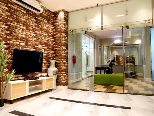 a living room with a brick wall and a tv at Al Alamein Suites in Tabuk
