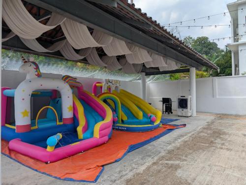 a group of inflatable slides in a play area at Luxury Tropical Bungalow in Damansara Golden Core in Kuala Lumpur