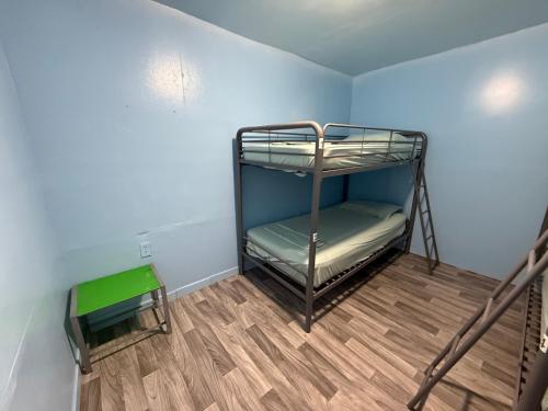 a room with a bunk bed and a wooden floor at OQP Vacations in Miami