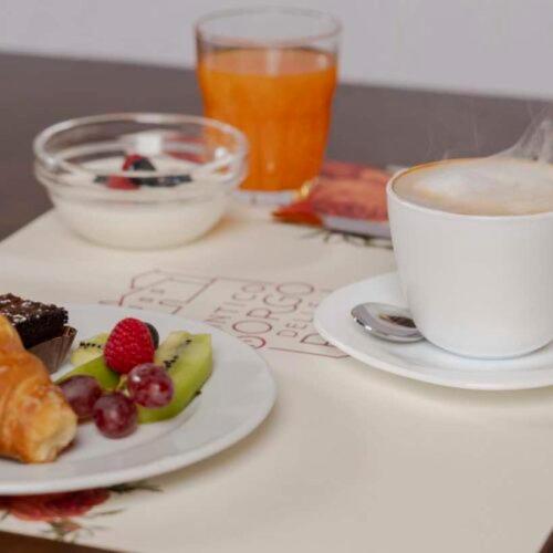 a table with a plate of food and a cup of coffee at Antico Borgo Delle Rose in Gricignano