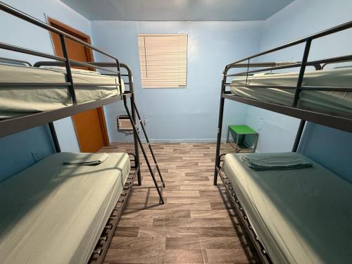 a room with two bunk beds and a window at OQP Vacations in Miami