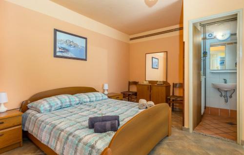 a bedroom with a bed and a sink in it at Villa Draga by Villas Guide in Mošćenička Draga