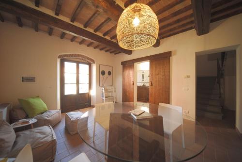 a living room with a glass table and a chandelier at Antico Borgo Delle Rose in Gricignano