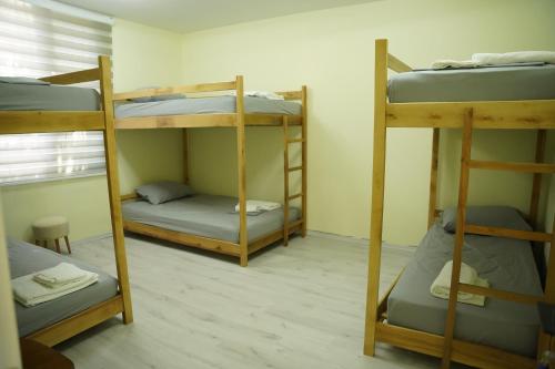 a room with three bunk beds in it at Lemon House in Tirana
