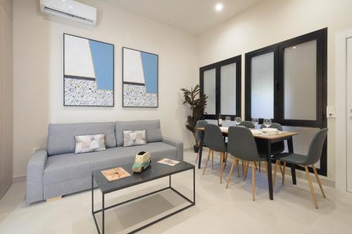 a living room with a couch and a table at Apartamentos Constitución in Granada