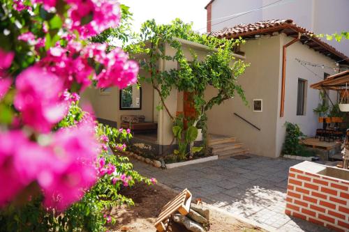 a house with pink flowers in front of it at Lemon House in Tirana