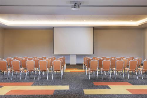 a conference room with chairs and a white screen at Park Inn By Radisson Iloilo in Iloilo City