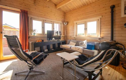 a living room with a couch and a chair at 1 Bedroom Stunning Home In Menaam in Dronrijp