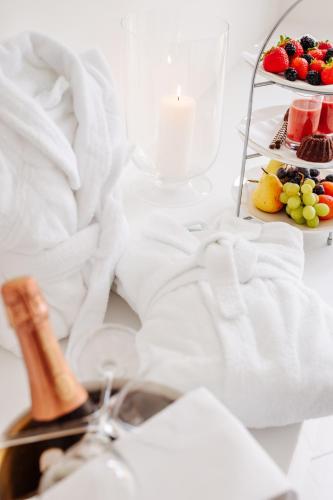 a table with a plate of fruit and a candle at Seehotel Dr. Jilly in Pörtschach am Wörthersee