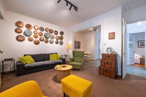 a living room with a couch and a table at City Cottage - Kalamata Villas in Kalamata