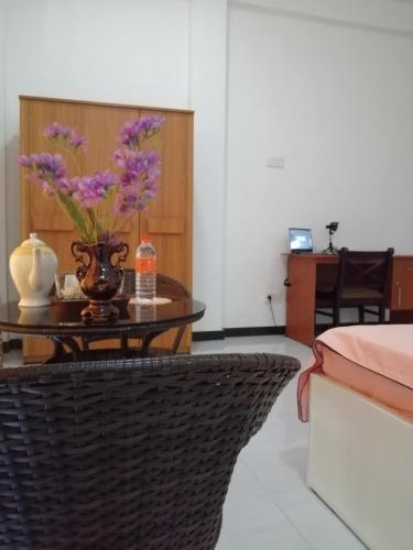 a room with a table with purple flowers on it at Colombo Airport Field View Villa in Dewamottawa