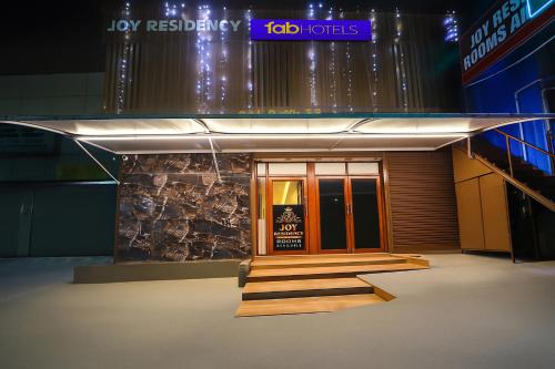 a building with a sign on the front of it at FabHotel Joy Residency in Chennai