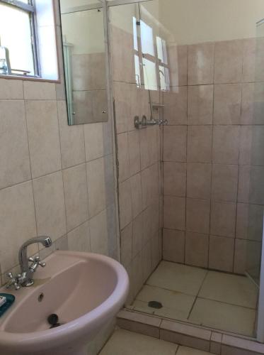 a bathroom with a shower and a sink at Tabonina Guesthouse in Livingstone
