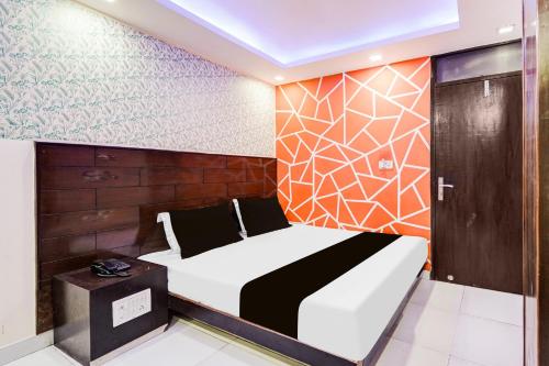 a bedroom with a bed and a wooden wall at Hotel O Priya Palace in New Delhi
