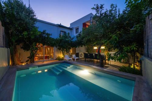 a swimming pool in the backyard of a house at City Cottage - Kalamata Villas in Kalamata