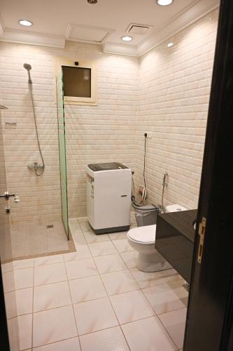 a bathroom with a shower and a toilet and a sink at Waad Chalet in Taif