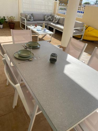 a table with green plates on top of it at Relax time! in Casas Devesa
