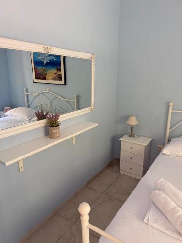 a bedroom with two beds and a mirror on the wall at Seaside Dream Kallithea in Kallithea Halkidikis