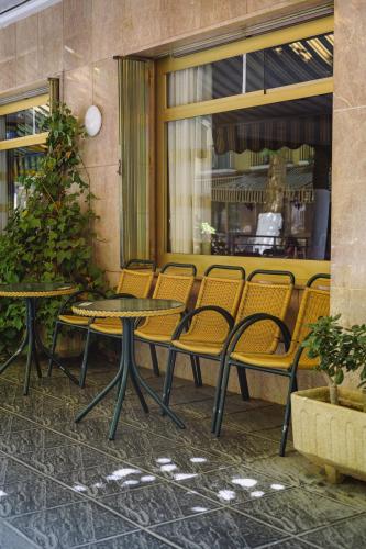 a patio with chairs and tables and a christmas tree at Hotel Paraíso in Lanjarón