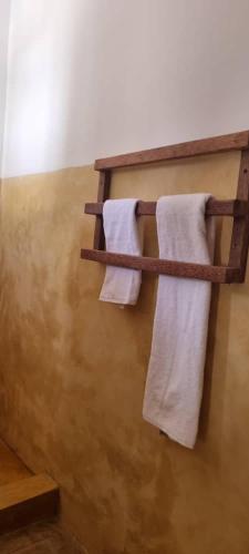 two towels are hanging on a towel rack in a bathroom at Pahali in Bwejuu