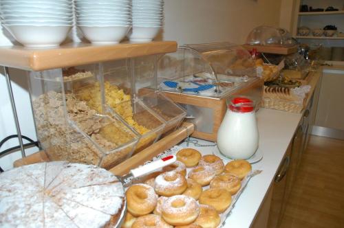 a bunch of donuts on a counter in a kitchen at Aparthotel Albatros in Lignano Sabbiadoro