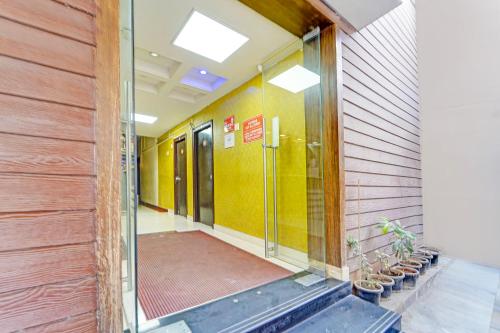 a hallway of an office building with a glass door at FabExpress Maruthi in Coimbatore