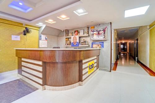 a lobby with a bar in a building at FabExpress Maruthi in Coimbatore