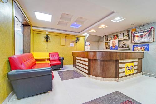 a waiting room with a bar and two chairs at FabExpress Maruthi in Coimbatore