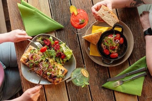 a table with a plate of food and a bowl of salad at Original Sokos Hotel Puijonsarvi in Kuopio
