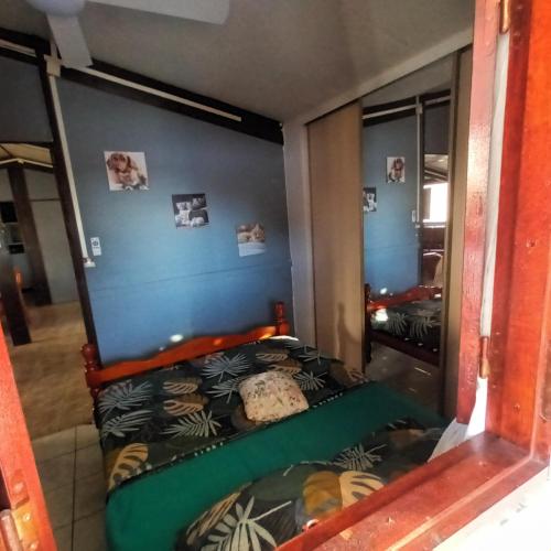 a bedroom with a bed in a room at Feunteun Veur in Saint-Paul