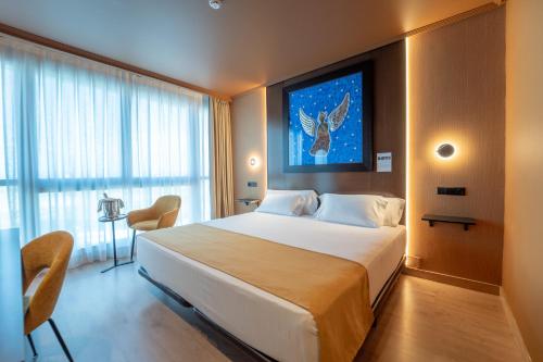 a bedroom with a large bed and a large window at Abba Playa Gijón in Gijón