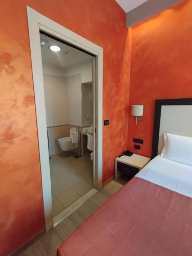 a hotel room with a bed and a bathroom at Hotel Continental in Turin