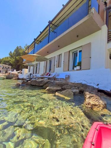 a house in the water in front of a house at Artis Blue Relax in Himare