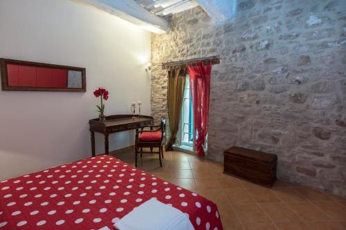 a bedroom with a bed and a desk in a room at Agriturismo Borgo Spagnoli in Magione