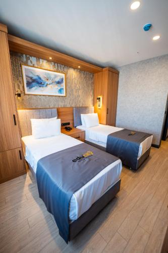 a hotel room with two beds in a room at Educity Suite and Hotels Atasehir in Istanbul