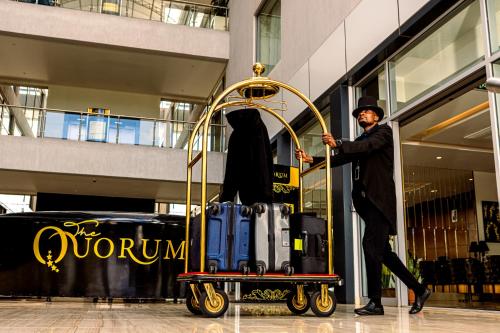 a man pushing a cart full of luggage in a mall at The Quorum in Lusaka