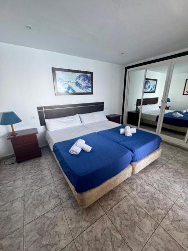 a bedroom with a large bed with towels on it at Apartamentos Mediterraneo in Marbella