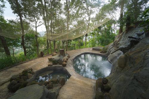 a hot tub in the middle of a forest at Alaya Stays Panchavadi Farm Stay in Thekkady