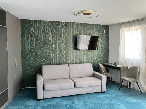 a living room with a couch and a table at Villa My Lake in Zamárdi