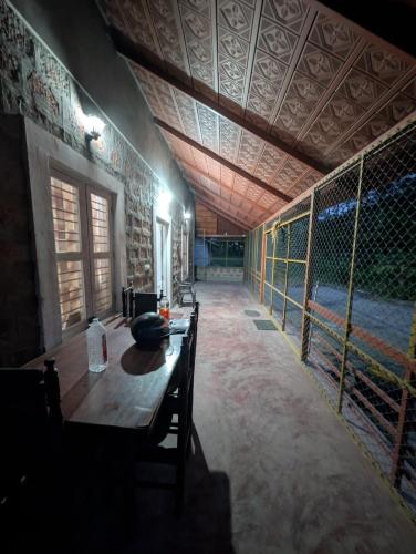 a room with a wooden table in a building at Mountain View Stay in Kushālnagar