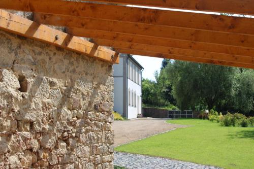 a stone wall with a building in the background at Apartment House - Oparno 16 in Velemín