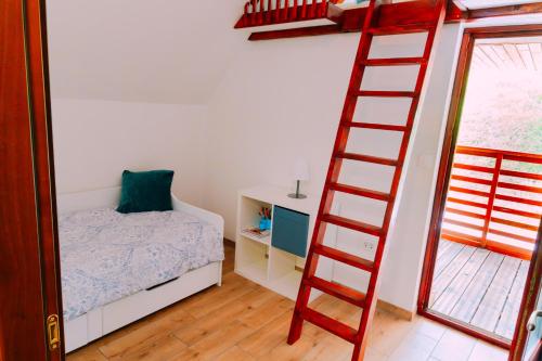 a bedroom with a ladder next to a bed at Apartma BoMa in Bovec
