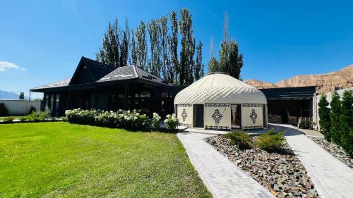 a gazebo in the yard of a house at Asylai Guesthouse in Naryn